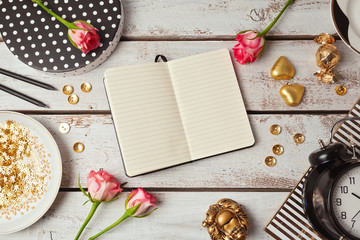 Notebook mock up with feminine objects. View from above