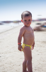 Baby playing in the water at the beach, Italy