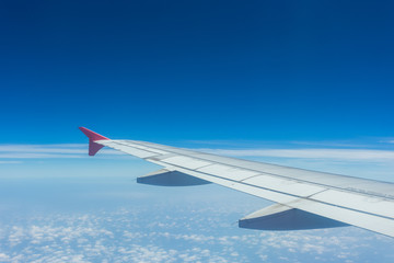 Clouds and sky as seen through window of an aircraft