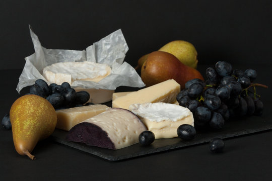 Assorted Cheese On Slate Stone. Grapes, Pears