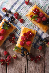cakes with berries, honey and mint close-up. vertical top view
