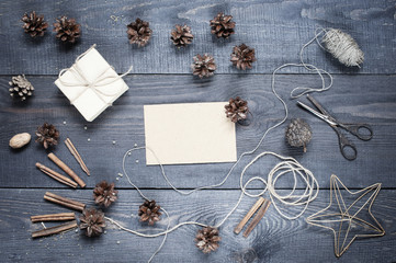 Blank postcard with composition on the dark wooden textured tabl