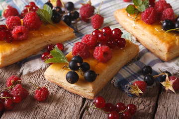 Delicious cakes with berries, honey and mint close-up. Horizontal
