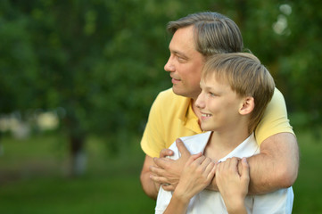 Father and son in summer park