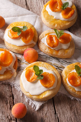 Apricot cake with sweet cream close-up on the table. Vertical
