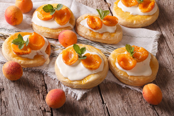 Apricot cake with sweet cream close-up on the table. Horizontal
