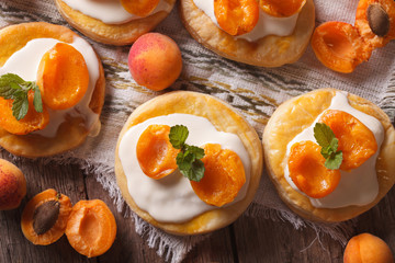 Apricot cakes with cream and mint close-up horizontal top view
