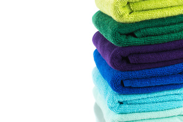 Pile of colorful clean towels isolated on white background