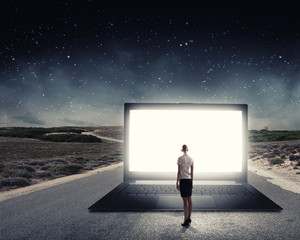 Fototapeta premium Woman standing on big laptop