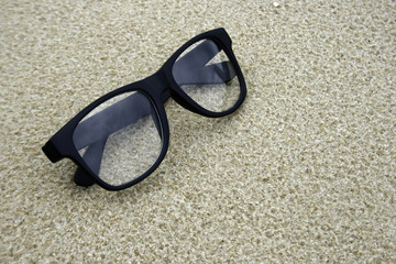 glasses in the sand at the beach with copy space