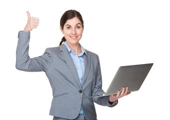 Young businesswoman hold with notebook computer and thumb up