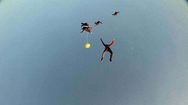 Skydiving tandem formation at the sunset. Friends meeting. Video HD