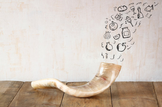 shofar (horn) on wooden table with set of infographics