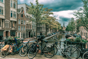 Obraz premium Amsterdam canal and bridge with bikes, Holland