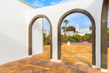Canary style building with view of buildings in marina Rubicon thorough arches, Lanzarote, Canary Islands, Spain