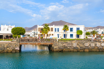 Fototapeta na wymiar Canarian buildings and footbridge in Rubicon port, Playa Blanca town, Lanzarote, Canary Islands, Spain