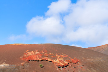 Red volcanic mountain landscape in Timanfaya National Park, Lanzarote, Canary Islands, Spain