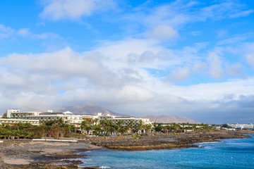 Hotel buildings on coast of Lanzarote island in Playa Blanca holiday resort, Canary Islands, Spain