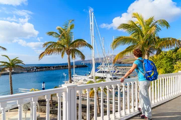 Foto op Canvas Young woman tourist looking at Puerto Calero marina built in Caribbean style, Lanzarote, Canary Islands, Spain © pkazmierczak