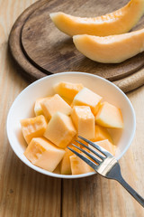 Cantaloupe in white dish with fork