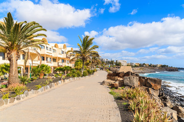 Hotel buildings along coastal promenade in Playa Blanca holiday resort town, Lanzarote island, Spain