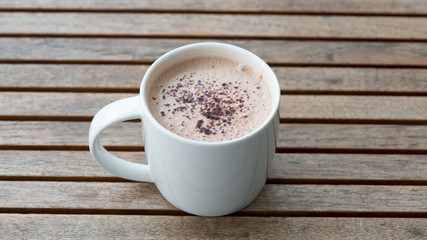 Hot chocolate in a white cup on table