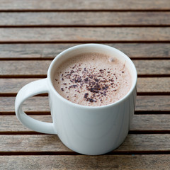 Hot chocolate in a white cup on table