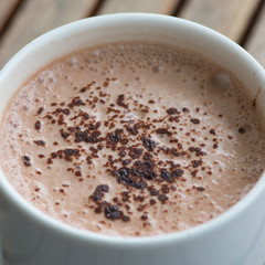 Hot chocolate in a white cup on table