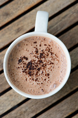 Hot chocolate in a white cup on table