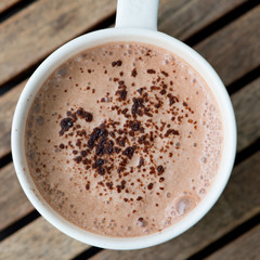 Hot chocolate in a white cup on table