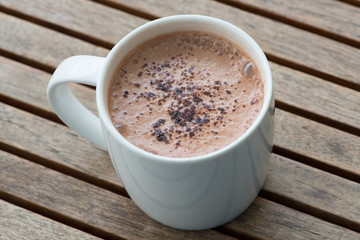 Hot chocolate in a white cup on table
