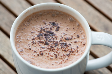 Hot chocolate in a white cup on table