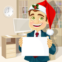 Businessman in cap of Santa Claus and with blank poster