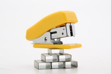 Stapler with staples yellow lines on a white background.