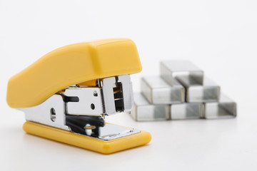 Stapler with staples yellow lines on a white background.