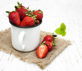 Metal cup with strawberries
