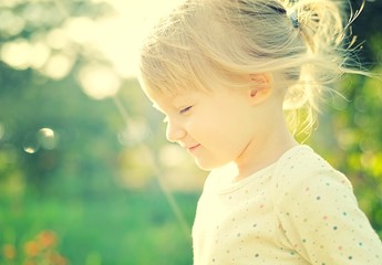 Cute little girl in the sunshine. Back lighting. © itsmejust