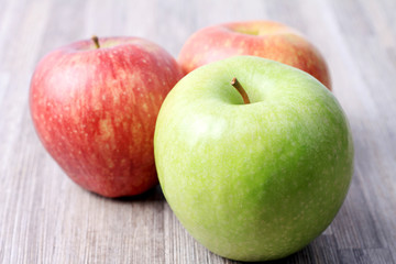 Fresh organic apples on wooden background