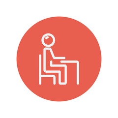 Student sitting on a chair in front of his table thin line icon