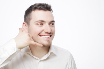 man gesturing mobile phone near his face
