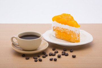 cup of coffee and delicious cake on white background
