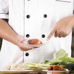 Chef present roasted chicken with noodle ingredient