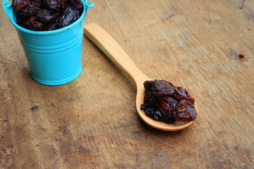 Heap of raisins on wood background