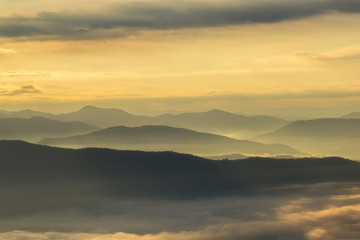 Fototapeta na wymiar Layer of mountains in the mist at sunrise time, Sri Nan National Park, Nan Province, Thailand