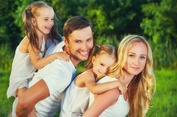 Fototapeta premium happy family on nature of summer, mother, father and children tw