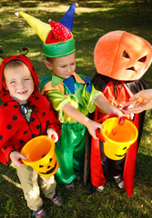 Three boys are getting their candies