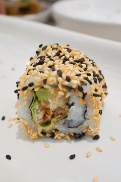 Maki Sushi - Roll with avocado,  Sesame outside.