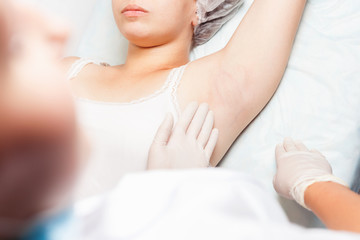 Obraz na płótnie Canvas Professional woman at spa doing epilation armpits using sugar, sugaring