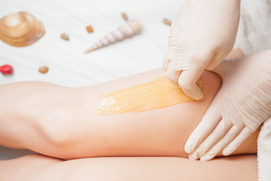 Sugaring epilation skin care with liquid sugar at legs. You can see her smooth and hair free armpits after hair removal.