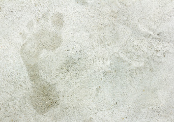 faded footprints in cement floor